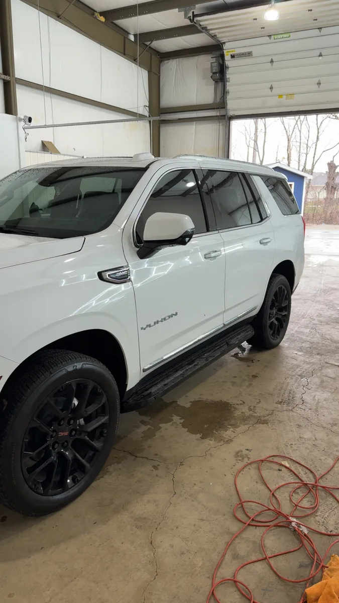 White Chevrolet Tahoe outside the shop after a wash