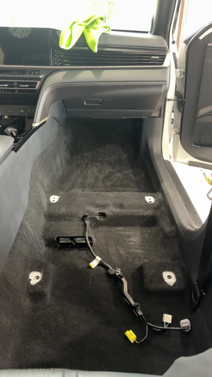 Vehicle interior with the seats removed and the floor pan exposed