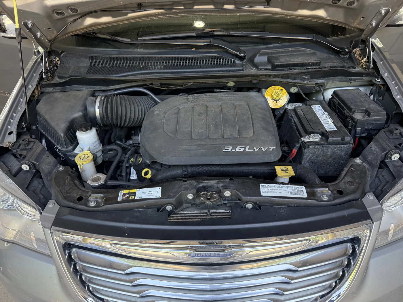 Chrysler 3.6 litre engine bay at check-in, covered in dust and road film