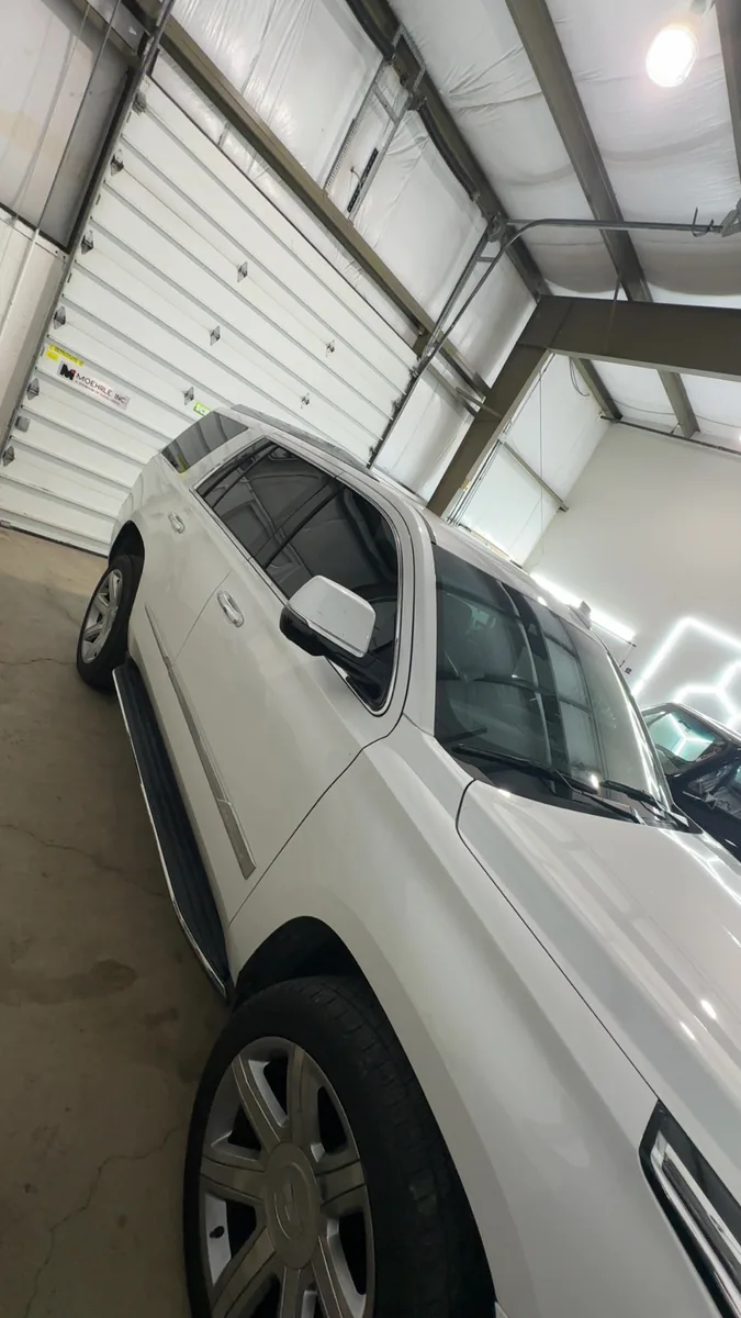 White Dodge Durango with tinted windows in the shop
