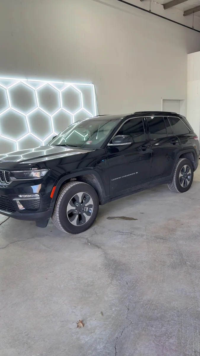 Black Jeep Grand Cherokee with tinted glass in the main bay